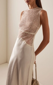 Detail of elegant sequin mesh and floral lace patchwork on an ivory evening dress