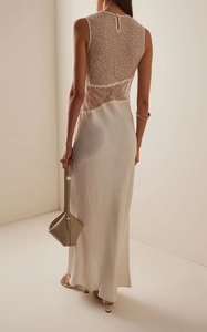 Detail view of the elegant lace stitching and back teardrop button on the satin evening gown