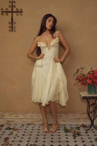 Close-up of cream vintage evening dress with 3D floral appliques and deep V-neckline