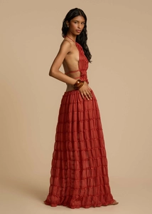 Detail of rust red halter dress with deep V backless design and layered pleats