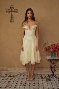 Detail of ivory evening dress featuring 3D floral appliques and lace-up neckline