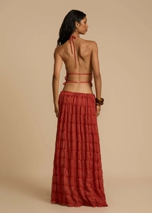 Detail view of terracotta tiered maxi skirt with backless halter top and lace-up design