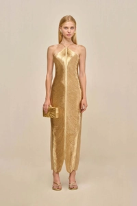 Detailed macro view of the gold metallic pleated texture and fringed fabric of the dress