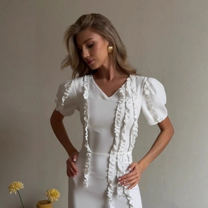 Elegant white party dress featuring stylish puff sleeves and ruffled V-neckline details