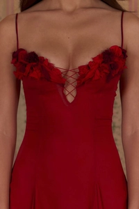 Close-up of elegant burgundy evening dress featuring 3D handmade roses and V-neck straps