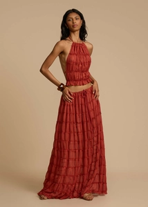 Detail of terracotta halter top with pleated texture and matching layered maxi skirt