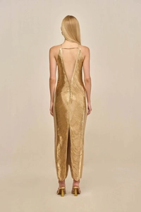 Detailed back view of a gold fringed gown featuring a deep V back and elegant slit detail