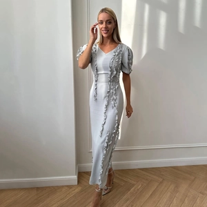 Elegant light blue V-neck maxi dress featuring puff sleeves and ruffle trim details
