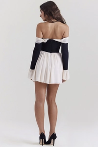 Detail of the back-tied pleated mini dress featuring a back zipper and elegant lace trim