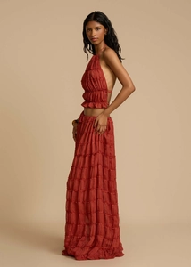 Detail of reddish-brown two-piece set featuring a halter crop top and layered maxi skirt