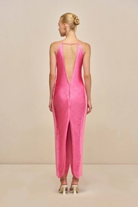 Back view of a pink fringe maxi dress featuring a halter neck and deep open back slit