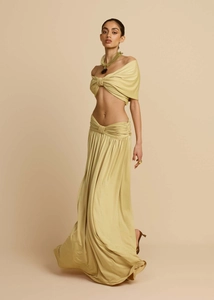 Detail of the twisted knot design on the off-shoulder top and the flowing maxi skirt
