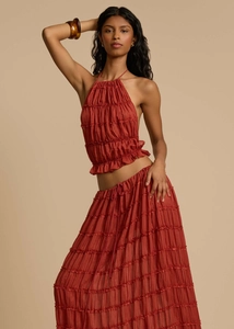 Detail of rust red halter top and layered maxi skirt with delicate ruffles and soft texture