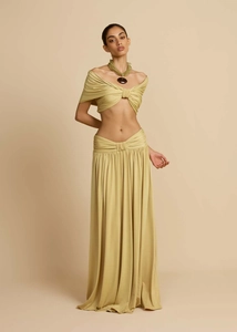 Detailed view of women's two-piece beach set featuring mustard yellow knot-front crop top