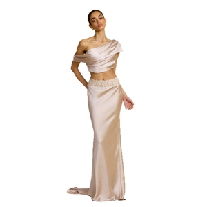 Elegant champagne satin two-piece evening gown with off-shoulder top and long trailing skirt