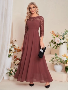 Detail of elegant dark burgundy lace bodice and flowing chiffon skirt on a floor-length gown