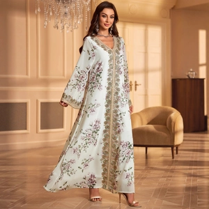White floral chiffon maxi dress with gold embroidery and long sleeves in luxury interior