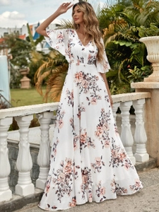 Elegant white floral V-neck maxi dress with ruffle sleeves shown in outdoor setting