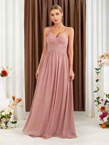 Detailed view of the V-neck pleated bodice and spaghetti straps on a dusty rose gown
