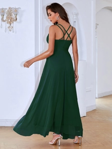 Macro shot of the elegant cross-back thin strap design on this dark green evening gown
