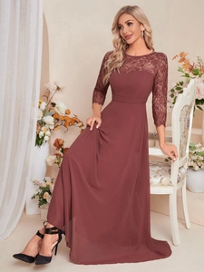 Detail of the elegant wine red lace bodice and sheer sleeves of the evening gown