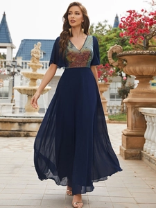 Detail of V-neck evening gown featuring colorful sequin bodice and navy chiffon skirt