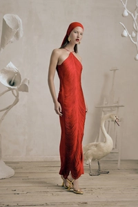 Close-up of red halter neck dress with fringe detailing and open back slit