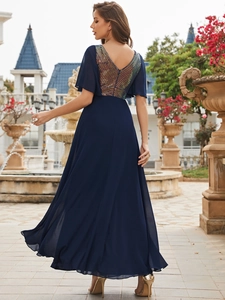 Detail of the back deep V-neckline with iridescent sequins on a navy evening gown