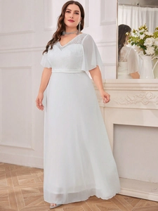 Detail of elegant V-neck lace embroidery and flowing ruffle sleeves on the evening gown