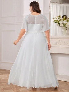 Detail of light blue lace embroidery on back and chiffon skirt of elegant maxi dress