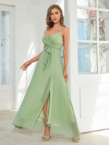 Detail of light green chiffon dress showing thin straps, V-neck, and side slit