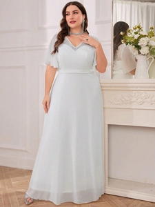 Detail of elegant V-neck lace bodice and sheer ruffle sleeves on a white evening gown