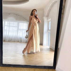 Detail of light apricot maxi dress with side slit, v-neck and waist tie bow detail