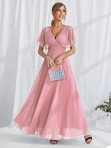 Detailed view of pink Swiss dot chiffon fabric and elegant V-neckline of long evening gown