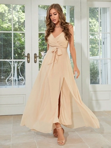Detail of elegant champagne v-neck evening dress featuring high slit and waist tie ribbon