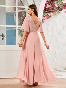 Detail of pink evening dress featuring a deep V-back design with shimmering sequins