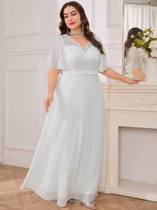 Detail of elegant V-neck white evening gown featuring delicate lace floral embroidery