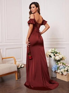 Detail of burgundy satin evening dress featuring an elegant lace-up back design
