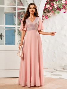 Pink V-neck evening gown featuring sequined bodice and flowy chiffon skirt