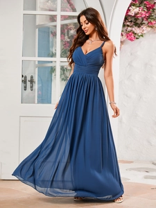 Detail of elegant navy blue evening dress with dual spaghetti straps and pleated waistline