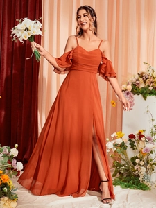 Detail of burnt orange cold shoulder maxi dress with ruffles and a high side slit
