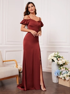 Detail of burgundy off-shoulder evening gown with ruffled sleeves and high slit leg