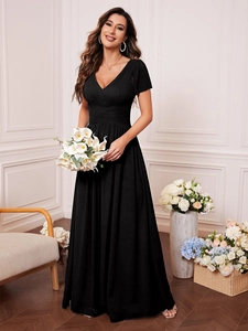 Detail of elegant black V-neck evening gown with pleated bodice and short sleeves