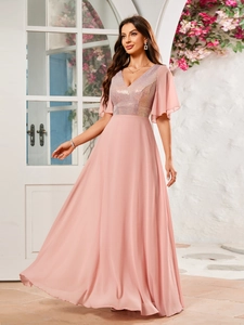 Close-up of elegant V-neck sequined bodice and ruffled sleeves on pink evening dress