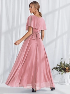 Detail of pink swiss dot maxi dress featuring ruffle sleeves and a waist bow tie