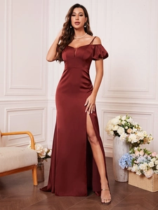 Detail of burgundy satin evening dress with off-the-shoulder puff sleeves and high slit