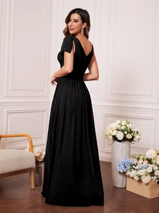 Close-up of the elegant bow shoulder detail and V-back on this slim black formal gown