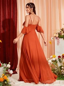 Detail of elegant brick red chiffon dress with cold shoulder ruffles and back zipper