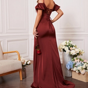 Detailed back view of burgundy evening dress showing criss-cross lace-up straps and silk satin