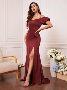 Detail of burgundy satin dress showing off-shoulder puff sleeves and high slit leg design